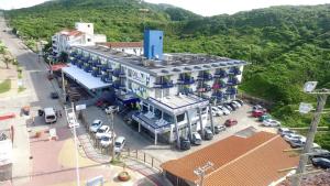 a building with cars parked in a parking lot at Cris Hotel in Florianópolis