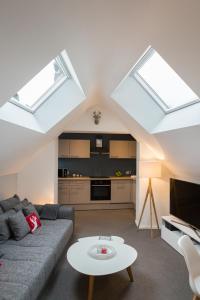a living room with skylights and a couch and a table at Le Coin Cocoon in Aywaille