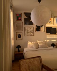a bedroom with a bed and a large white lamp at Cozy Top-Floor Studio in Turku - Near City Center in Turku