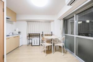 a kitchen and dining room with a table and chairs at Shinjuku Raise OG House in Tokyo +64 photos