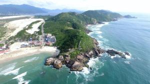 an aerial view of a island in the ocean at Cris Hotel in Florianópolis
