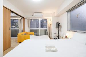 a hotel room with a bed and a window at Shinjuku Raise OG House in Tokyo