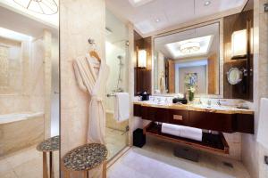 a bathroom with a large mirror and a sink at The Ritz-Carlton, Chengdu in Chengdu