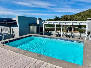 a large blue swimming pool on top of a house at 18 on The Den Studio Apartment in Stellenbosch