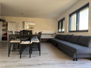 a living room with a couch and a table and chairs at Vogesenblick in Bad Bellingen