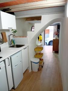 a kitchen with white cabinets and a sink at Calderona Tiny house in Segorbe