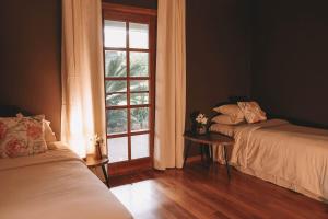 a bedroom with two beds and a window at The Riverside Homestead - 8 guests in Bellbrook