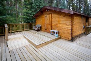 a wooden cabin with a bench on a deck at HI Athabasca Falls - Hostel in Jasper