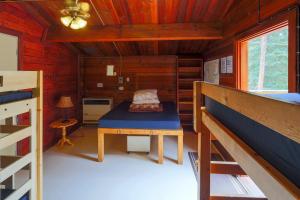 a room with a bed and a table in a cabin at HI Athabasca Falls - Hostel in Jasper