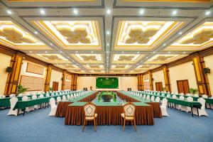 a conference room with tables and chairs and a screen at Bayon Era Hotel in Siem Reap +77 photos