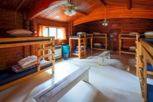 a room with bunk beds in a wooden cabin at HI Athabasca Falls - Hostel in Jasper