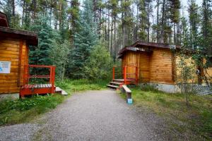 a couple of wooden buildings in a forest at HI Athabasca Falls - Hostel in Jasper