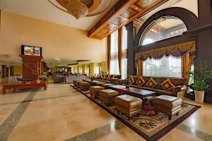 a lobby with couches and chairs in a building at Bayon Era Hotel in Siem Reap