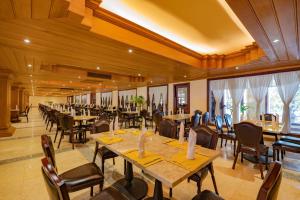 a large dining room with tables and chairs at Bayon Era Hotel in Siem Reap