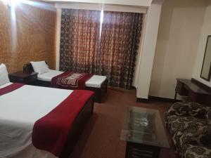 Postel nebo postele na pokoji v ubytování Hotel Al badar