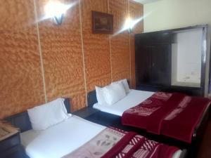 Postel nebo postele na pokoji v ubytování Hotel Al badar