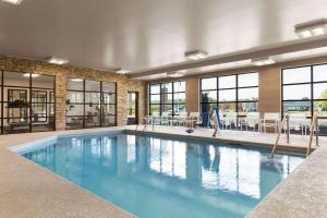 a large swimming pool with blue water in a building at Country Inn & Suites by Radisson, Smithfield-Selma, NC in Smithfield