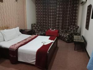 Postel nebo postele na pokoji v ubytování Hotel Al badar