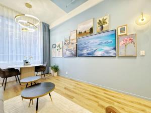 Una sala de estar con una mesa y un gran cuadro en la pared. en Modern Elegance - CBD Luxury 1BR on Central Queen St, en Auckland