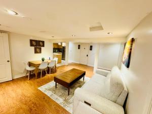 a living room with a couch and a table at Spacious and Modern Family-Friendly 2-Bedroom Apartment - Near Airport & Toronto Downtown in Brampton