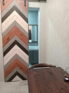 a wooden table with a chair in front of a wall at Kasa Boutique Hotel in Cebu City +33 photos