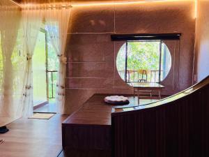 a living room with a table and a window at Gió Homestay - Pleiku in Pleiku