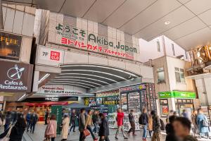 a crowd of people walking in a shopping mall at Mori hotel Akihabara 2 in Tokyo