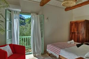a bedroom with a bed and a large window at Villa Aquilo in Megali Ammos +33 photos