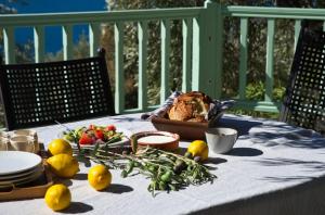 a table with vegetables and a basket of food on it at Villa Aquilo in Megali Ammos