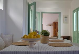 a table with a bowl of fruit on top of it at Villa Aquilo in Megali Ammos