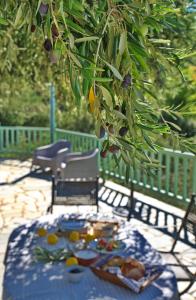 a table with a blue table cloth with food on it at Villa Aquilo in Megali Ammos