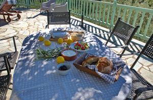 a table with a plate of bread and fruit on it at Villa Aquilo in Megali Ammos