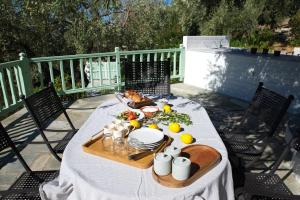 a table with a plate of food on a patio at Villa Aquilo in Megali Ammos