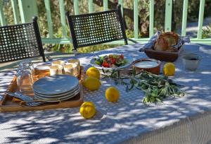 a table with a plate of food and lemons on it at Villa Aquilo in Megali Ammos