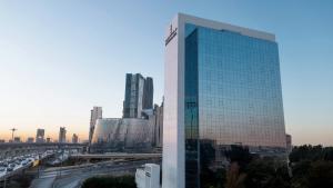 a tall building in a city with a highway at Executives Hotel - KAFD in Riyadh