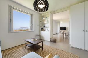 a living room with a table and a window at Villa Zabbara in Favignana