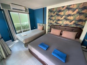 Postel nebo postele na pokoji v ubytování Rayonghouse Resort
