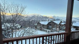 a view from a balcony of a house in the snow at Appartement 'Paradi Ski, Bike & Hike' in Montalbert