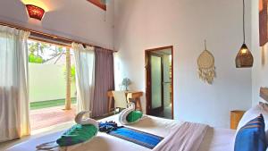 Postel nebo postele na pokoji v ubytování Kies Villas Lombok