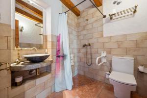 a bathroom with a sink and a toilet at Mas Fullat casa rural Alforja in Alforja +30 photos