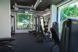 a gym with several tread machines and a window at Azur Premium Resort in Saints Constantine and Helena