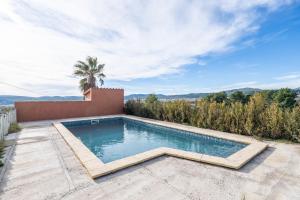 a swimming pool in the backyard of a house at Mas Colom-Can Cruset Agroturisme in Torrellas de Foix +17 photos