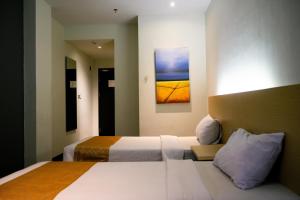 Postel nebo postele na pokoji v ubytování Yunna Hotel Lampung