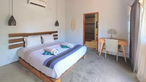Postel nebo postele na pokoji v ubytování Kies Villas Lombok