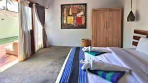 Postel nebo postele na pokoji v ubytování Kies Villas Lombok