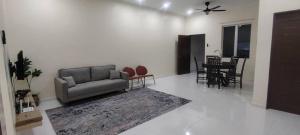 a living room with a couch and a table at MAB Homestay in Alor Setar