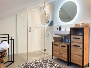 a bathroom with a shower and a sink and a mirror at Das Coming Home in Baunatal in Baunatal