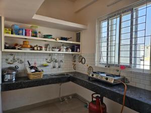 a kitchen with a sink and a window at Pearl Homes Hyd in Hyderabad