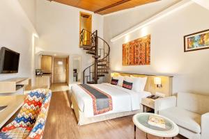 a bedroom with a bed and a living room at Sterling Manali in Manāli