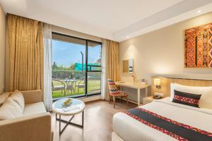 a hotel room with a bed and a couch at Sterling Manali in Manāli +71 photos